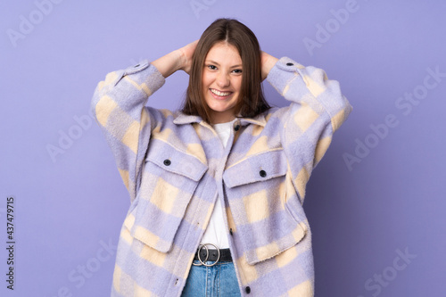 Teenager caucasian girl isolated on purple background laughing