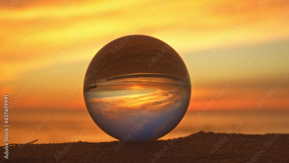 The natural view of the sea and sky in beautiful sunset are unconventional and beautiful inside crystal ball. .A image for a unique and creative travel idea. The natural view of the sea and sky in beautiful sunset are unconventional and beautiful inside crystal ball. .A image for a unique and creative travel idea.