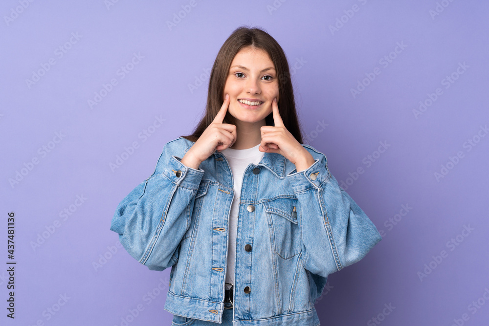 Teenager caucasian girl isolated on purple background smiling with a happy and pleasant expression Teenager caucasian girl isolated on purple background smiling with a happy and pleasant expression