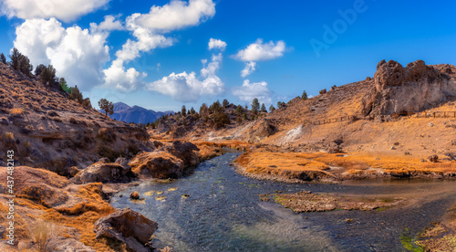 View of natural Hot Springs at Hot Creek Geological Site. Located near Mammoth Lakes, California, United States. Blue Sky Sunny Day Colorful Art Render