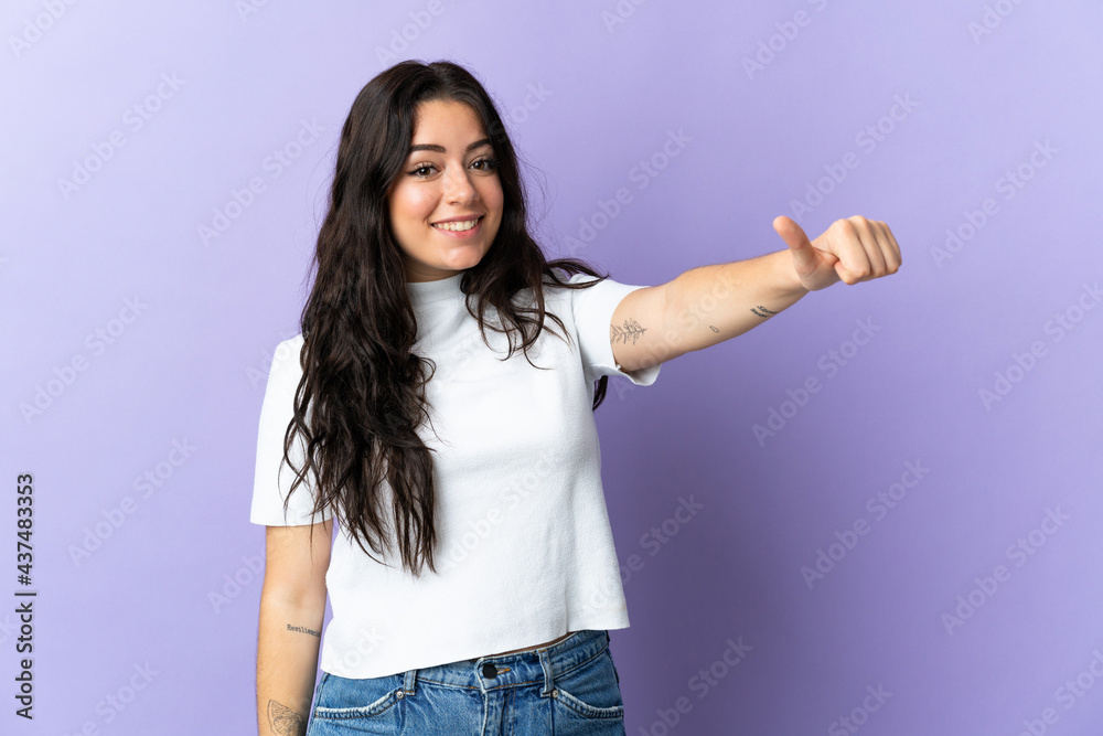 Young caucasian woman isolated on purple background giving a thumbs up gesture Young caucasian woman isolated on purple background giving a thumbs up gesture