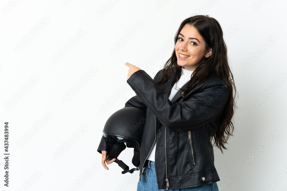 Woman holding a motorcycle helmet isolated on white background pointing back Woman holding a motorcycle helmet isolated on white background pointing back