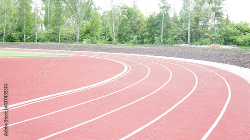 Running track in red with a carbon coating around the stadium with white dividing stripes