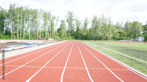 Running track in red with a carbon coating around the stadium with white dividing stripes © Vladimir Jhirov