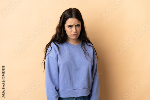 Young caucasian woman over isolated background with sad expression © luismolinero