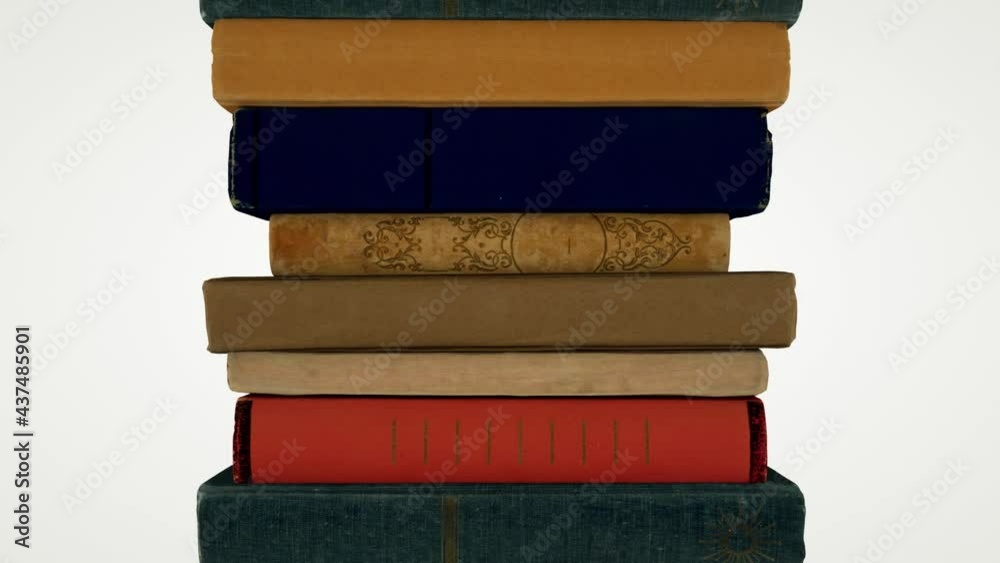 The camera pans up to show a stack of old books. Seamless loop.