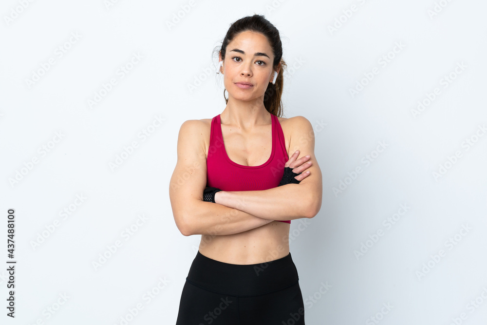 Sport woman over isolated white background with arms crossed Sport woman over isolated white background with arms crossed