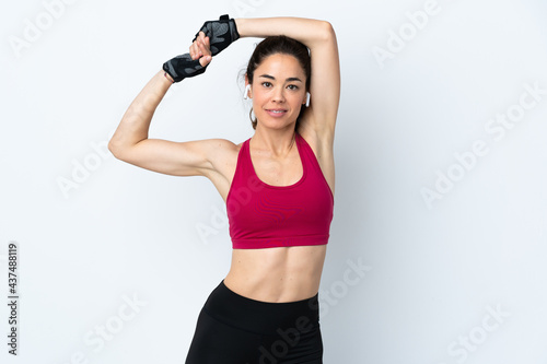 Sport woman over isolated white background stretching © luismolinero