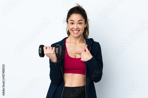 Sport woman making weightlifting over isolated white background with surprise facial expression