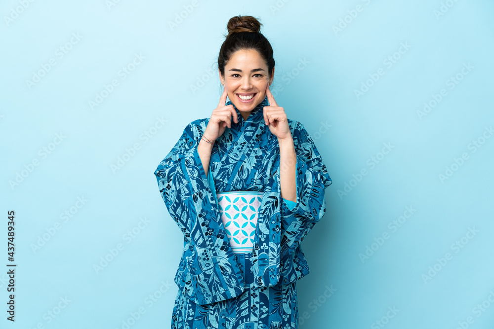 Woman wearing kimono over isolated background smiling with a happy and pleasant expression Woman wearing kimono over isolated background smiling with a happy and pleasant expression