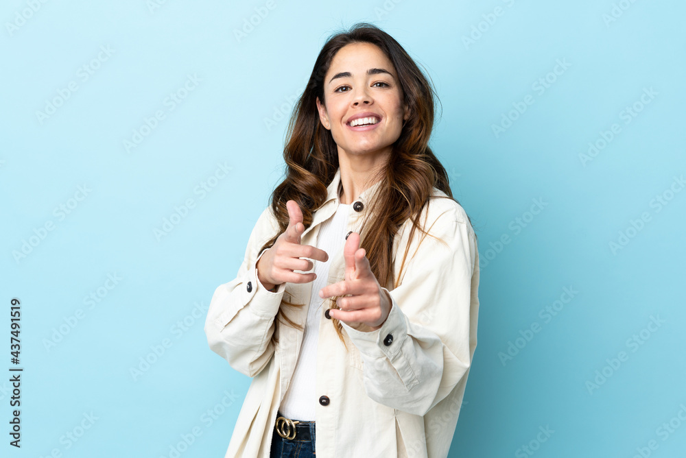 Woman over isolated background pointing to the front and smiling Woman over isolated background pointing to the front and smiling