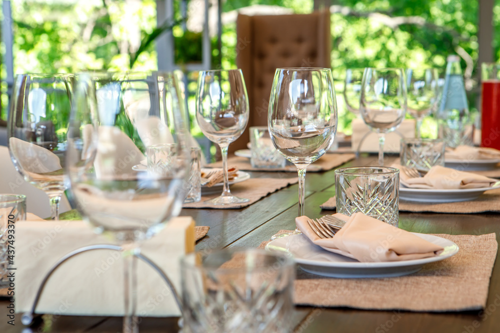 Empty wine glasses are on the table. A fragment of the serving.