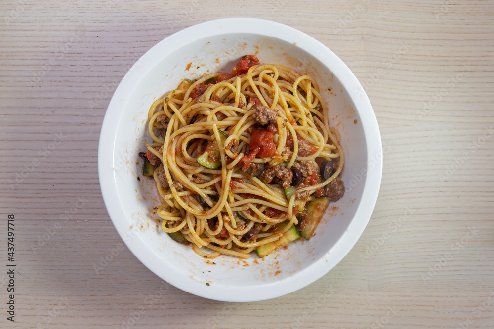 A bowl of spaghetti with tomato based sauce.