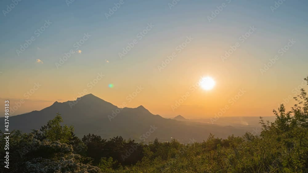 Amazing summer landscape with dramatic foggy sunrise. Sun rays emerge through the clouds in the mountains at sunrise. Amazing summer landscape with dramatic foggy sunrise. Sun rays emerge through the clouds in the mountains at sunrise.