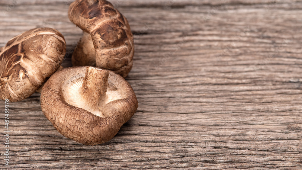 Shiitake mushrooms on the wooden background..Shiitake mushroom on wooden table. Shiitake mushrooms on the wooden background..Shiitake mushroom on wooden table.