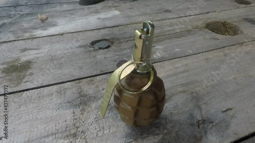 the man hand puts a Russian f-1 grenade on the table