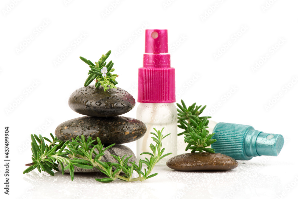 Fresh rosemary flowers ,green leaves and extracted in the spray bottle isolated on white background.