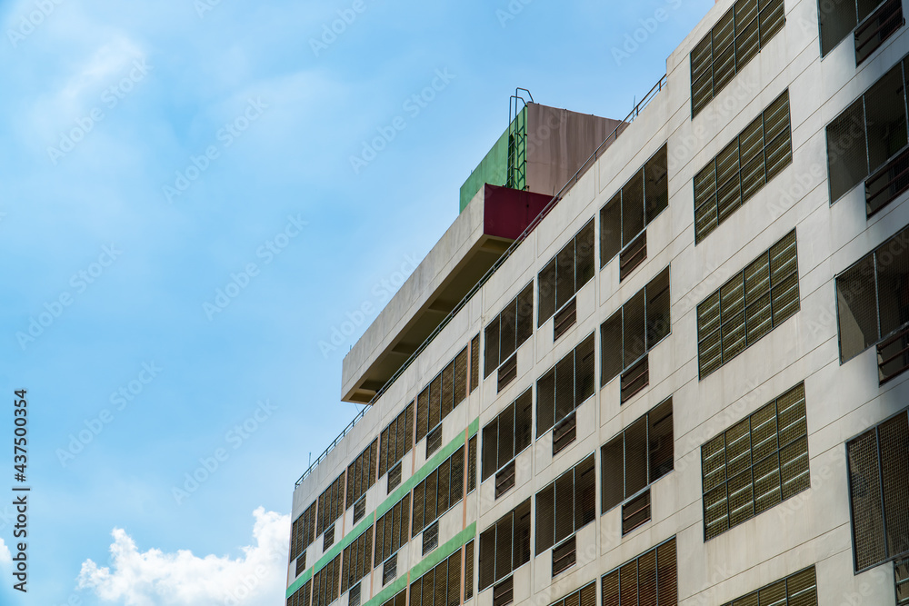 building with cage on blue sky and clouds background. copy space for text.