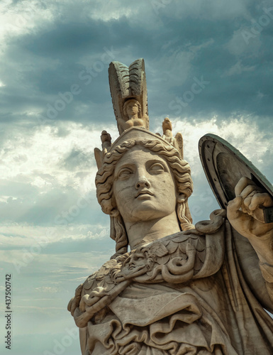 Athena  the ancient Greek goddess of wisdom and knowledge under dramatic cloudy sky  Athens Greece