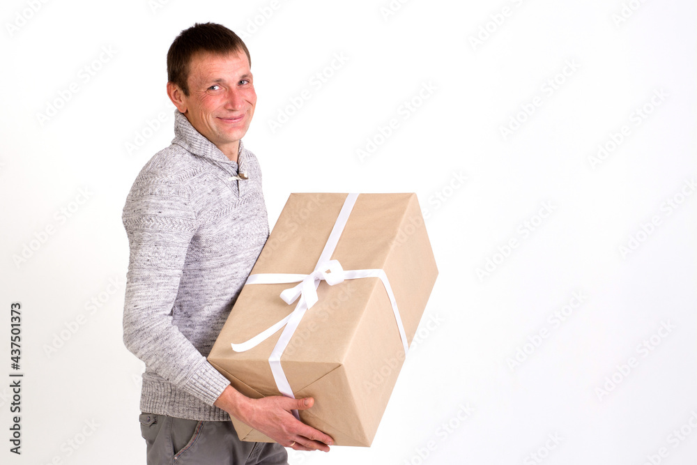 Handsome smiling man with big gift on white background Handsome smiling man with big gift on white background