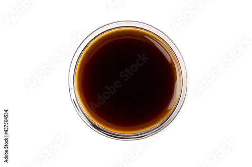 Dark caramel syrup or Soy sauce , isolated on white background. Top view.