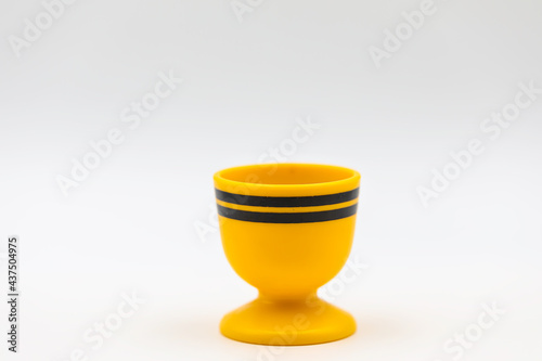 Yellow egg cup or egg holder  isolated on white background. photo