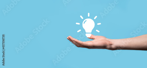 Hand hold light bulb. Holds a glowing idea icon in his hand. With a place for text.The concept of the business idea.Innovation, brainstorming, inspiration and solution concepts
