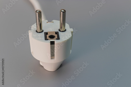 EU plug on a gray background. Home electrician. Close-up. Full focus. copy space.