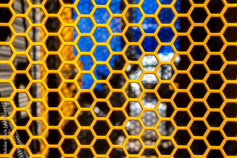 Yellow metal texture steel background. Perforated sheet metal. Stock