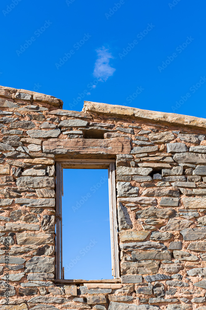 The ruins of the stone walls and window frame of a settlers homestead along the Oodnadatta track in outback South Australia.