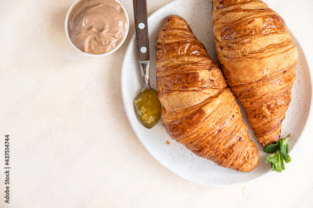 Croissants with jam and chocolate cream, light concrete background. Top view. Croissants with jam and chocolate cream, light concrete background. Top view.