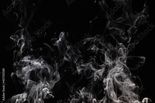 White rising smoke on a black background. Graphic effect photo