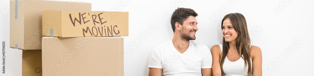 The smile couple drink coffee near boxes The smile couple drink coffee near boxes