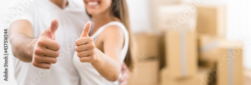 The happy woman and man gesture on the background of the carton boxes