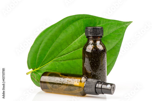 Piper betle green leaves and extracted in the bottles  isolated on white background. photo