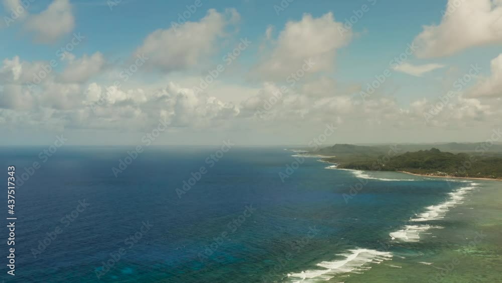 Tropical island with forest and ocean with surf and coral reef top view. Summer and travel vacation concept Tropical island with forest and ocean with surf and coral reef top view. Summer and travel vacation concept