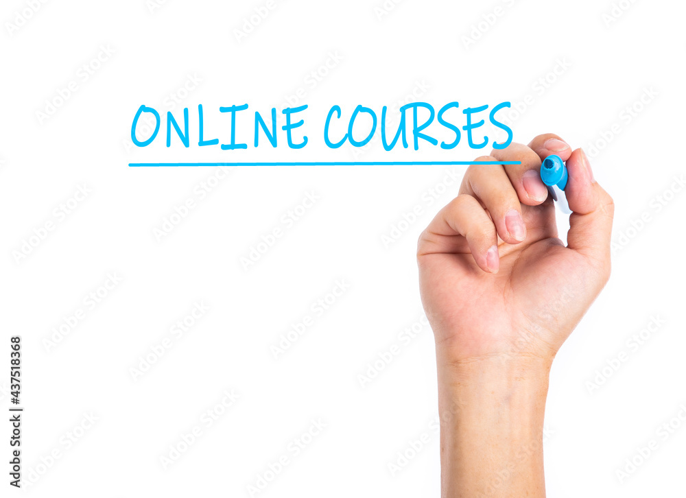 Man hand writing ONLINE COURSES on a transparent wipe board. Man hand writing ONLINE COURSES on a transparent wipe board.