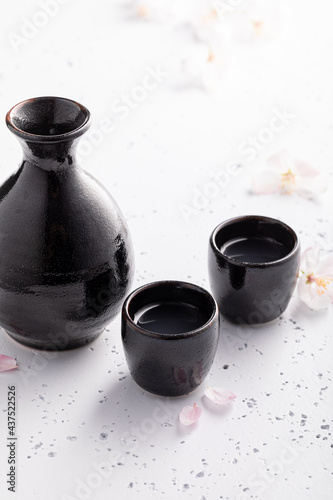 Strong sake in black ceramics. Japanese habit of drinking alcohol.