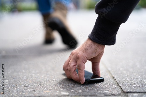 Person Picking Up A Lost Wallet
