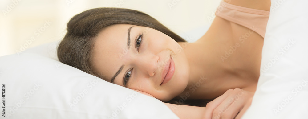 The cute woman lay on the bed The cute woman lay on the bed