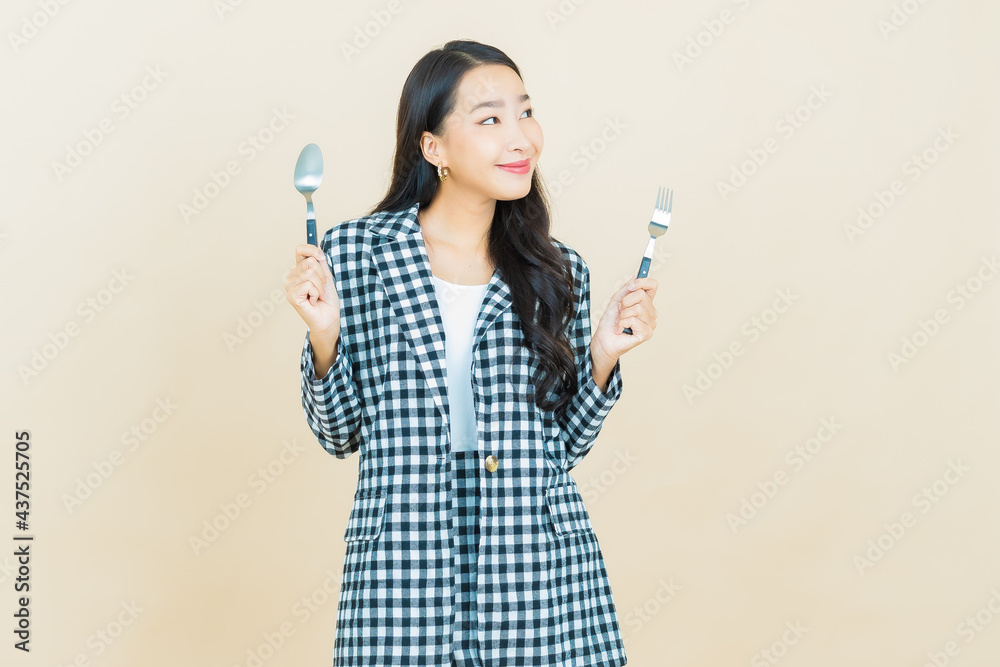 Portrait beautiful young asian woman smile with spoon and fork Portrait beautiful young asian woman smile with spoon and fork