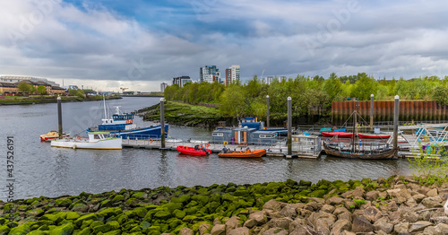 A view of boats moored on the River Kelvin where it joins the River Clyde in Glasgow on a summers day