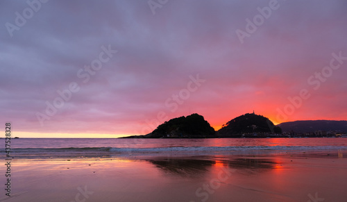 Sunrise in La Concha bay from Ondarreta beach, city of Donostia-San Sebastian, Euskadi