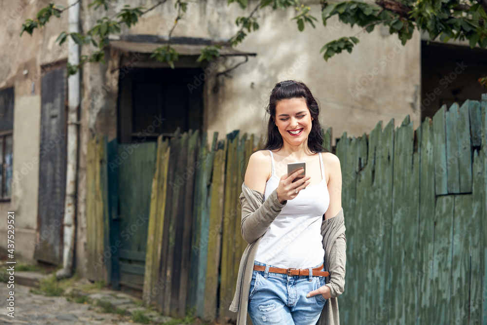Young cute female using smartphone on the street. Young cute female using smartphone on the street.