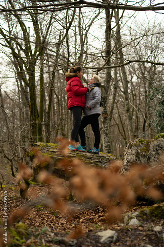 women mountaineers help each other walking along a trail