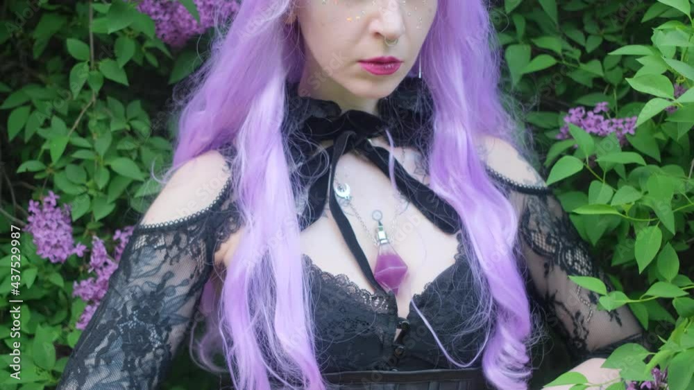 Nymph with purple hair in the forest with lilac flowers. Nymph with purple hair in the forest with lilac flowers.
