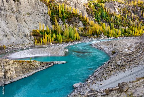 Turquoise water of Hunza River and color of Autumn this beautiful picturesque spot is situated at Karimabad Hunza Valley Gilgit Baltistan Pakistan  photo