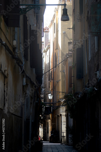 View of a Venice narrow street  In dialect  Calle    in the early morning. Old but charming backstreet under a delicate sun beam.