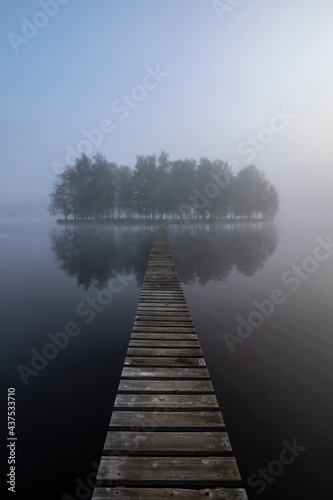 wooden bridge on island in fog