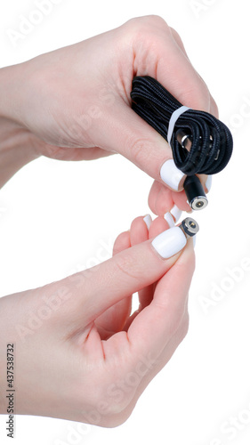 Magnetic USB cable in hand on white background isolation